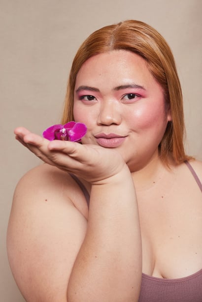 Curvy Woman with Bold Makeup and Flowers